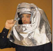 Man wearing silver and clear Lakeland 311-AGL Aluminized Approach Hood on brown background